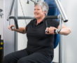 image of an older woman working on gym equipment