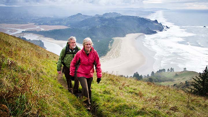 Senior couple hiking above coast