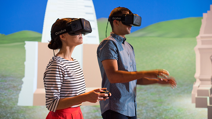 Two people wearing Virtual Reality (VR) headsets