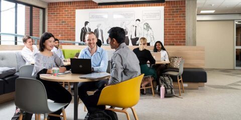 Finance research students at Curtin University working together in a communal meeting space